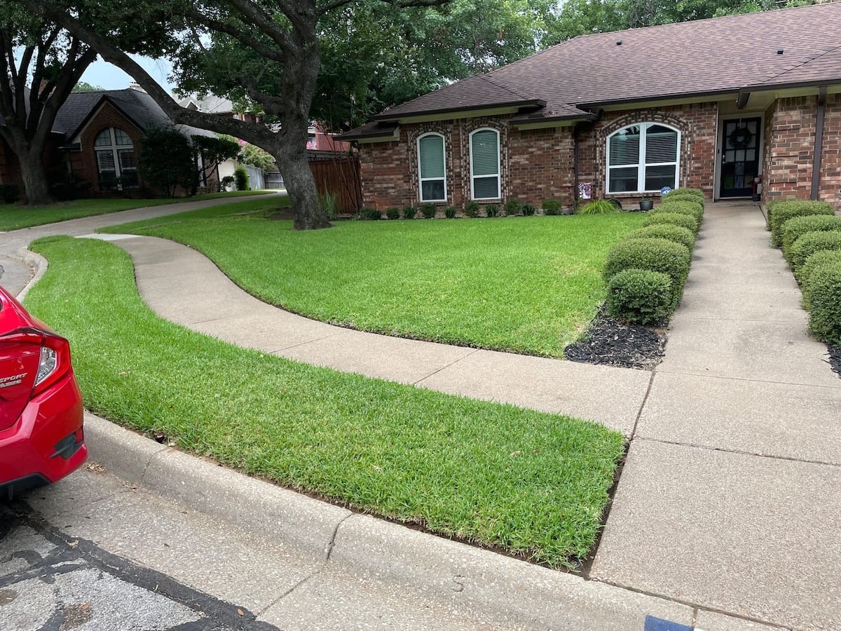 Lawn care professionals boosting a home’s curb appeal.